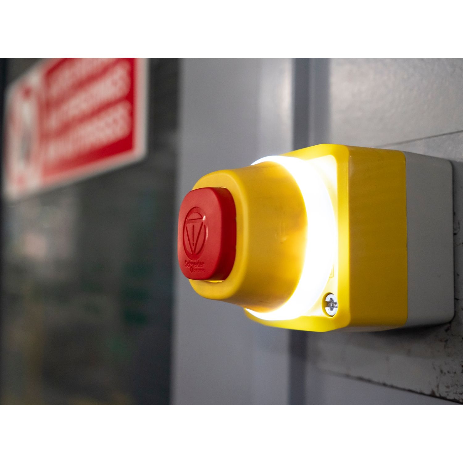 Picture of Control station, Harmony XALD, plastic, yellow lid, 1 emergency stop 40mm, turn to release, illuminated ring white red fixed, 1NO 1NC, 24V AC DC